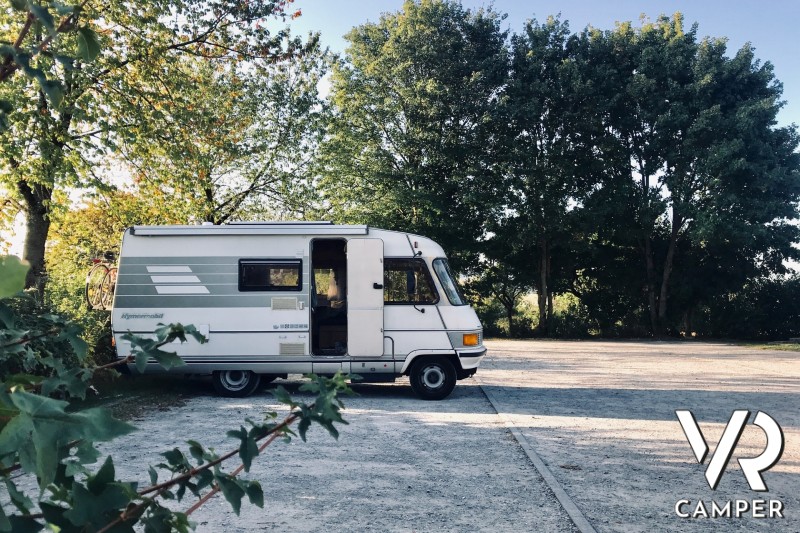 Used vintage Hymer motorhome parked on a camp in the nature.